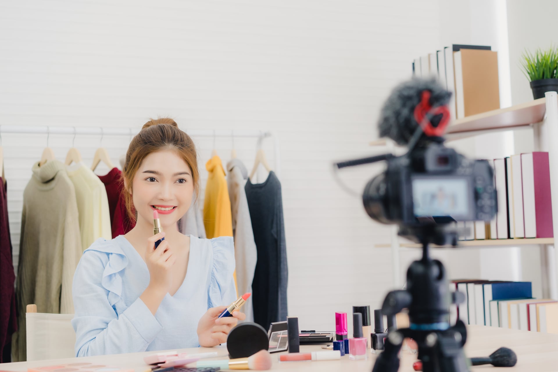 beauty blogger present beauty cosmetics while sitting front camera recording video 1347